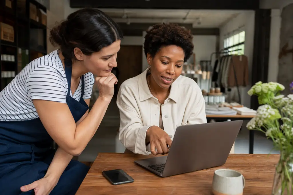 Two people researching together on a laptop